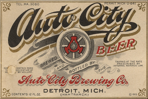 Beer label for Auto City Beer with a logo featuring an automobile tire with graphics in black, gold, and red on a beige background. Text reads “Tel. MA.3080 Permit Mich-U-641 Auto City Beer Brewed and Bottled by the Auto City Brewing Co. Detroit, Mich. (Hamtramck) Tax Paid at the Rate Prescribed by Internal Revenue Law Contents 12 FL. Oz. c 1915”