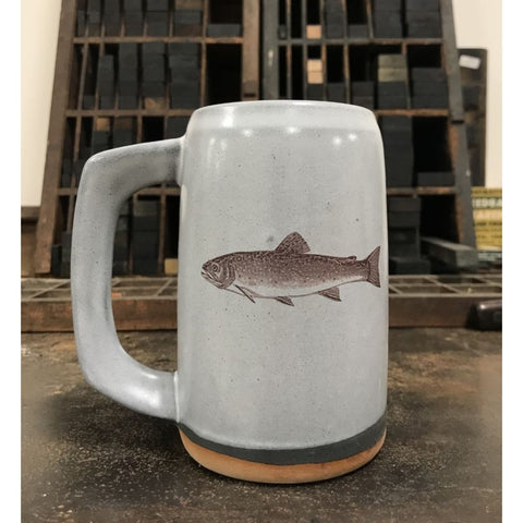 A light gray ceramic stein with an image of a brook trout imprinted on the front.