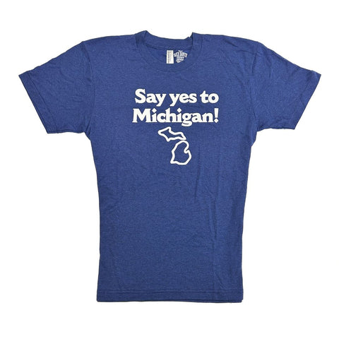 Front of a blue t-shirt featuring the text in white lettering “Say yes to Michigan!” with a white outline of the state of Michigan beneath it.