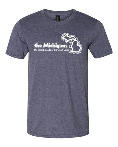 A heathered blue t-shirt with a white logo on the chest that reads “The Michigans the almost islands of the Great Lakes” with an outline of the state of Michigan.