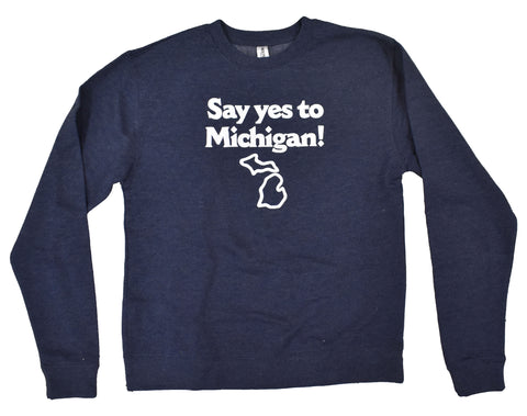 A navy blue crewneck sweatshirt with a white logo on the chest that reads “Say yes to Michigan!” with an outline of the state of Michigan underneath it.