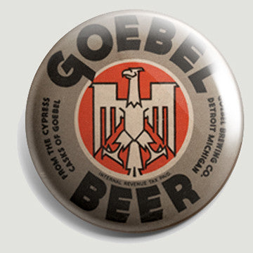 The front of a round bottle opener magnet featuring the logo for Goebel Beer. Text on the label reads “Goebel Beer From the Cypress Casks of Goebel Goebel Brewing Co. Detroit Michigan” and features black text on a brown background with a red and white eagle logo in the center.