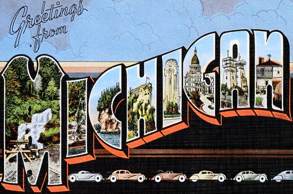 Historical postcard with stylized text that reads “Greetings from Michigan.” The design features various city and landscape scenes within the block letters of “Michigan” and shows a line of different colored cars on the bottom. The design is on a light blue and black background.