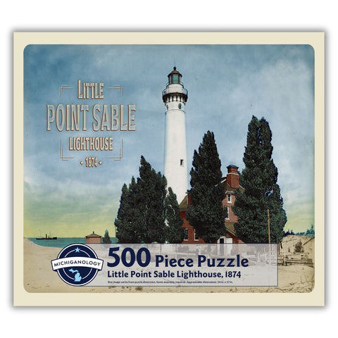 Colorized historical image of Little Point Sable Lighthouse and keeper’s dwelling. Puzzle cover text reads “500 Piece Puzzle Full Image Insert Included inside this box! Little Point Sable Lighthouse, 1874 Box image varies from puzzle dimensions. Some assembly required. Approximate dimensions: 17 in. x 24 in.”