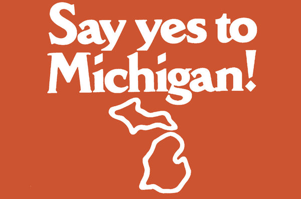 Logo for “Say yes to Michigan!” in bold white text with a white outline of Michigan underneath it on an orange background.