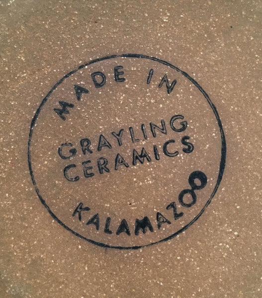 Close-up of underside of stein. A circular black ink stamp that reads “Grayling Ceramics Made in Kalamazoo”